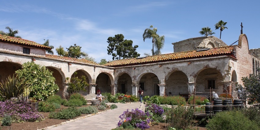 Mission San Juan Capistrano with old, broken walls of the building and unique flowers, one of the historical places in San Antonio.