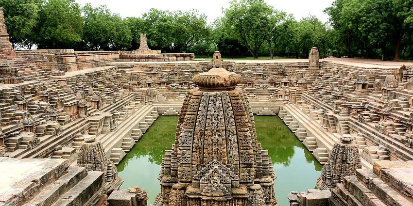 Ancient stepwell and intricately carved pillars of the Modhera Sun Temple in Gujarat.