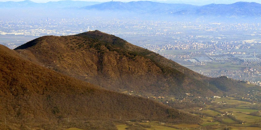 Panoramic view of the Monte San Giorgio mountain with trees, rocky cliffs, one of the monuments in Switzerland.