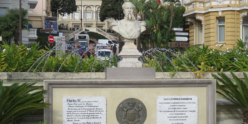 Monument of Charles III with a fountain and panels with information written on the structure