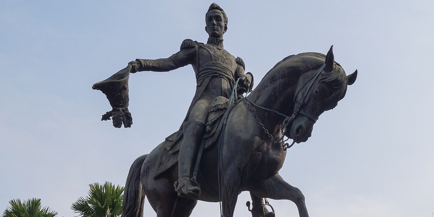 Simón Bolívar monument on horseback holding a hat, symbolising leadership and courage.