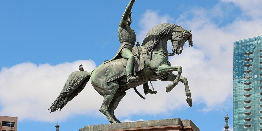 Statue of General San Martin in Buenos Aires with intricate carvings and buildings in the back, one of the famous monuments in Argentina.