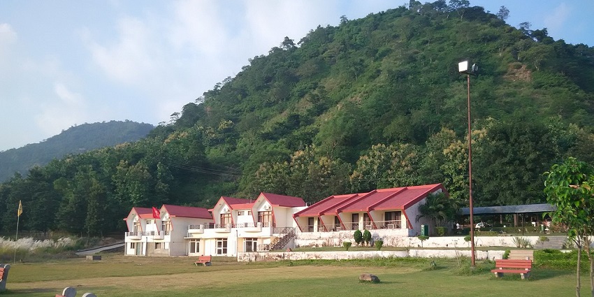 Scenic view of Morni Hills and Tikkar Taal with thick green forests and surrounding rolling hills.