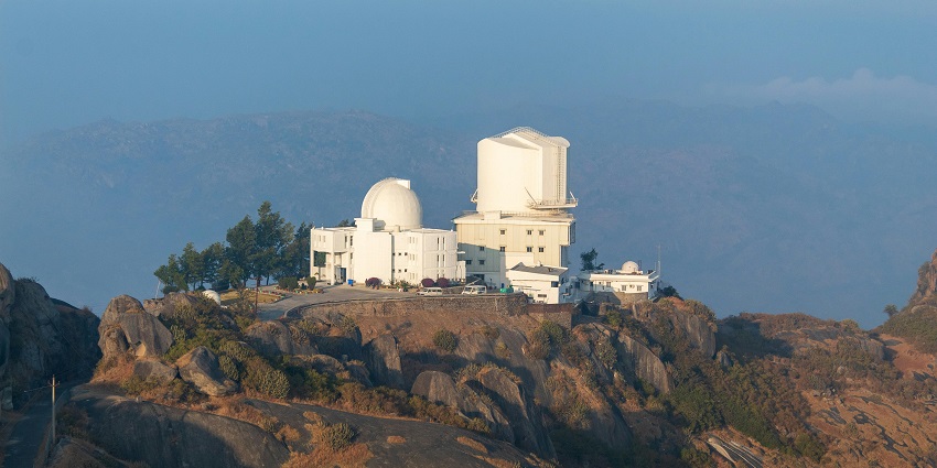 Modern infrared telescope dome at Mount Abu Observatory under a clear sky in Rajasthan.