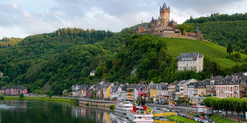 European townscape with grey rooftops and clustered buildings under a cloudy sky