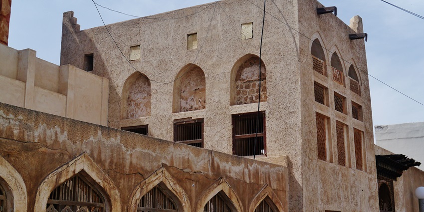 Traditional houses with wind towers in Muharraq, renowned historical places to visit in Bahrain for cultural insight.
