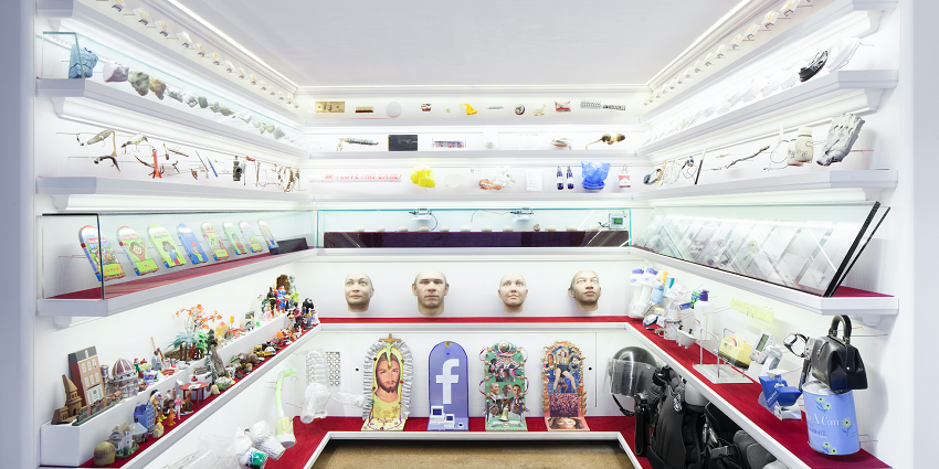 Interior of Museum with multiple antiques like face masks, dollar bills, bags and bottles