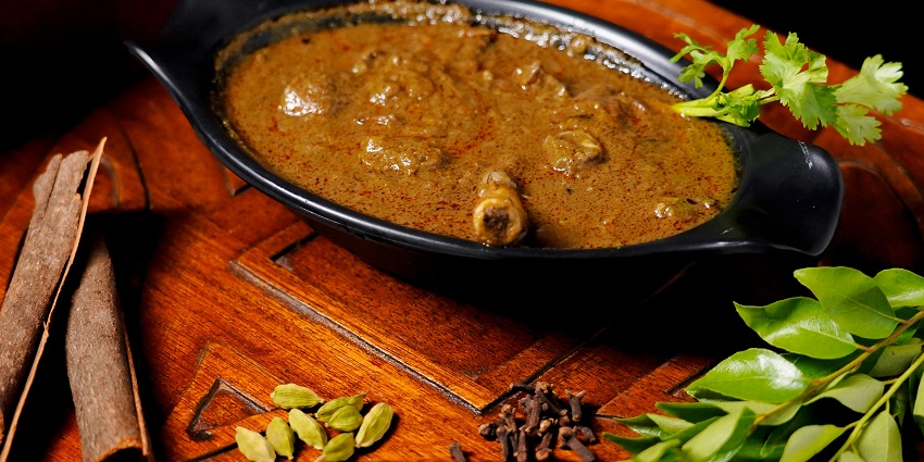 Spicy mutton curry served in Kolkata style showing what is the main food of Kolkata