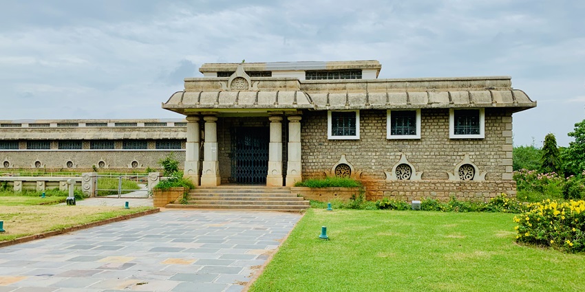 Nagarjunakonda Archaeological Museum building surrounded by greenery and blue sky