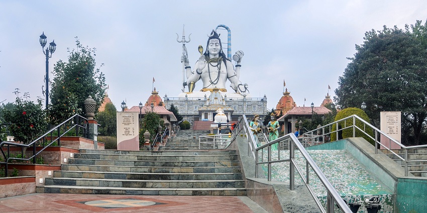 View of the giant Shiva statue at a hilltop temple complex, one of the top places to visit in Sikkim in August.