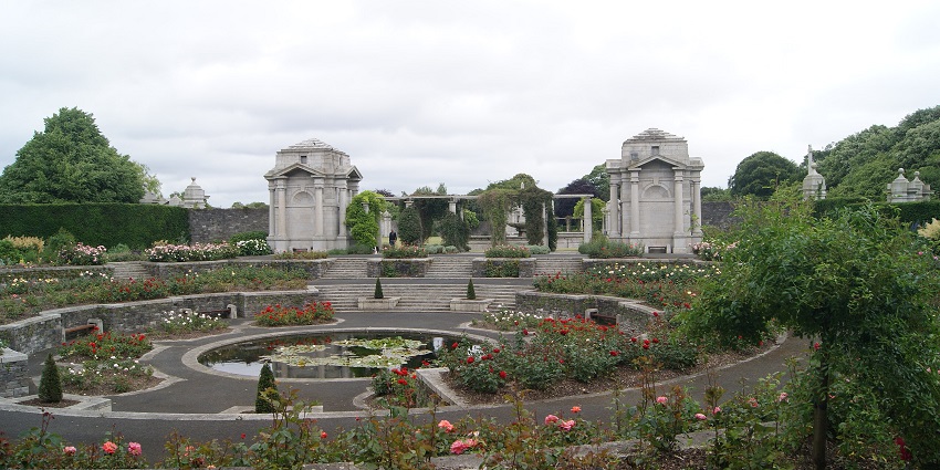 National War Memorial Gardens featuring flowery trees, green lawns, and stone monuments