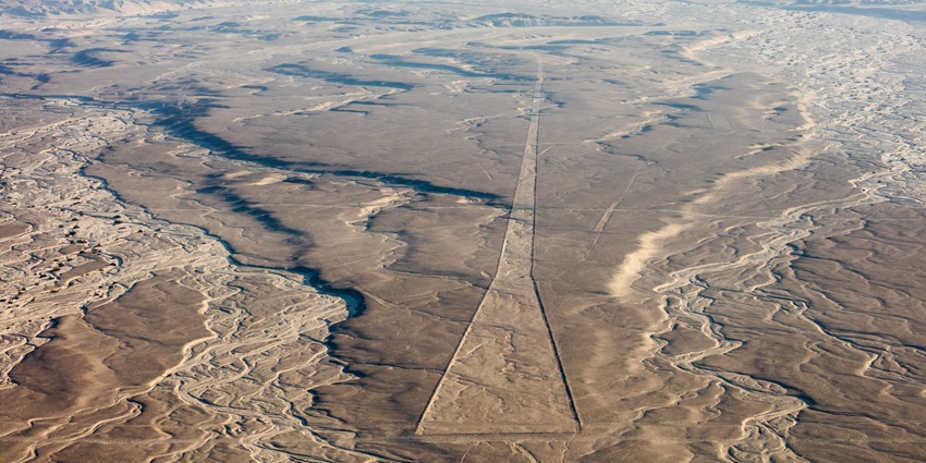 Aerial view of a large land with etched Nazca Lines, one of the monuments in Peru.