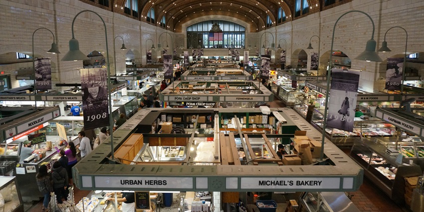 Indoor market stalls are lined with local fruits, vegetables, and jars of homemade preserves.