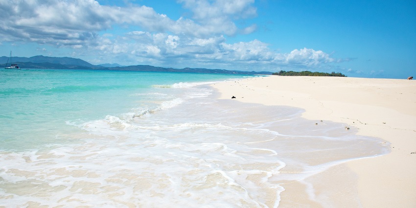 A scenic view of Nosy Komba island in Madagascar with blue ocean and clear sunny skies.