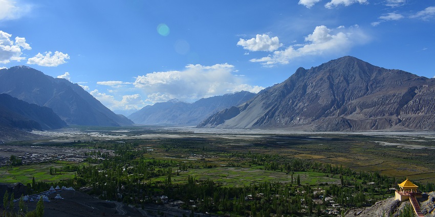 Expansive dunes meet snowy peaks in Nubra Valley, a surreal desert in the Himalayas.