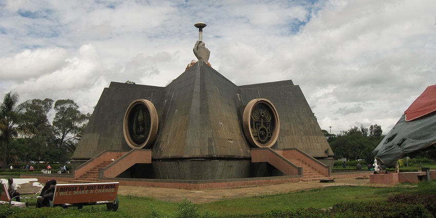 Wide view of the Nyayo Monument in Nairobi under a beautiful blue sky, showcasing its grandeur.