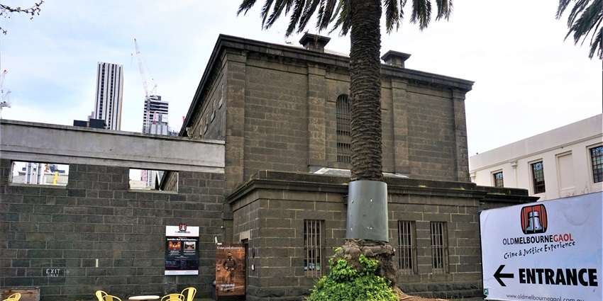 Stone walls and barred windows of Old Melbourne Gaol, one of the must-see historical places in Melbourne
