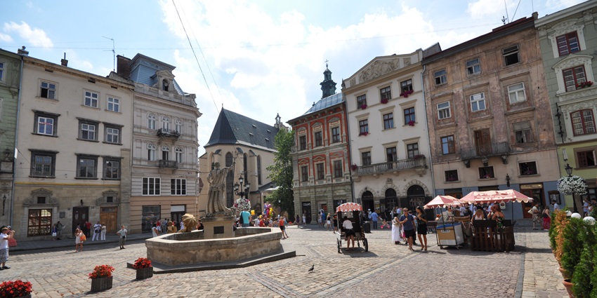 Rynok Square in the old town of Lviv with cobblestone streets, statue of neptune in the center, one of the top historical places in Ukraine.