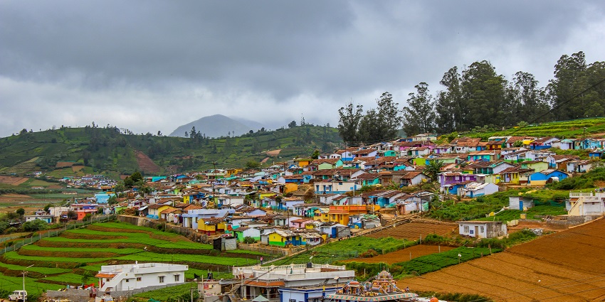 Charming hillside cottages surrounded by lush greenery, one of the places near Coimbatore.