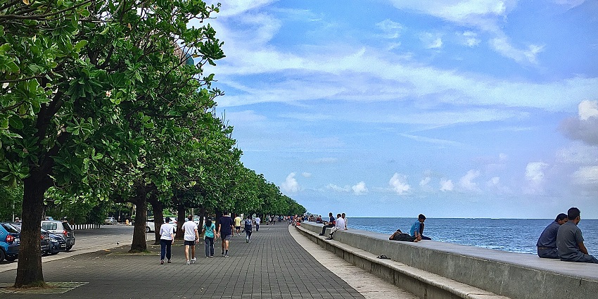 Scenic view of a morning at the famous Marine drive, with people sitting and walking by
