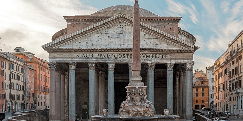 Pantheon in Rome with architecture, a tall pillar, detailed carvings and people sitting.