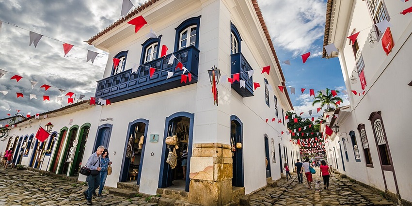 Paraty's historic centre with white architectural buildings, white & red flags, Brazil