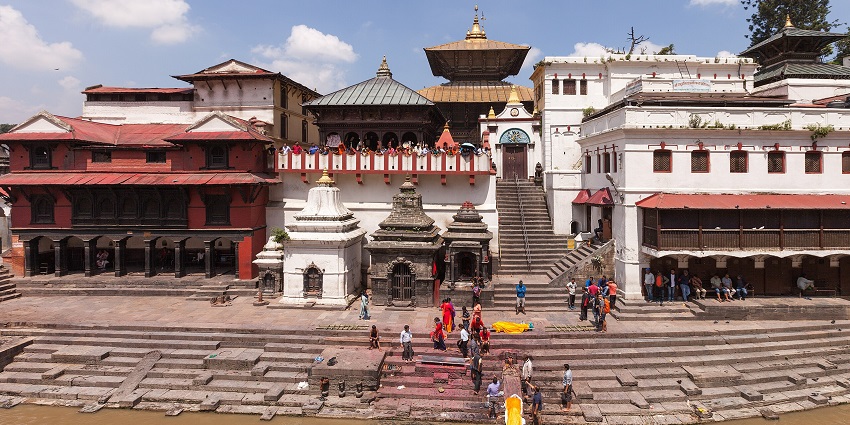 Pashupatinath Temple Complex of Nepal, with many visitors, and the Bagmati River in front.