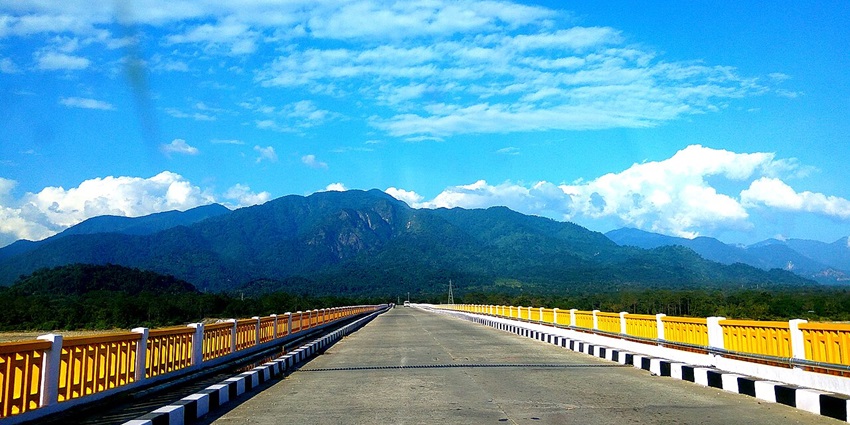 Bridge in Pasighat with yellow railings of the bridge, set amidst lush green mountains