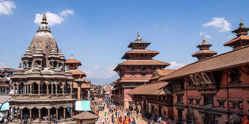 Grand view of Patan Durbar Square bustling with visitors, showcasing historic architecture.