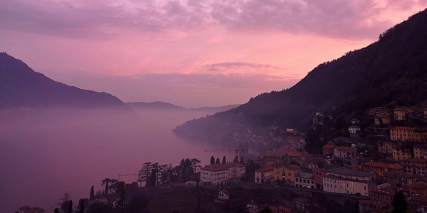 An enigmatic click represents a beautiful pink lake during dusk, covered with white clouds.