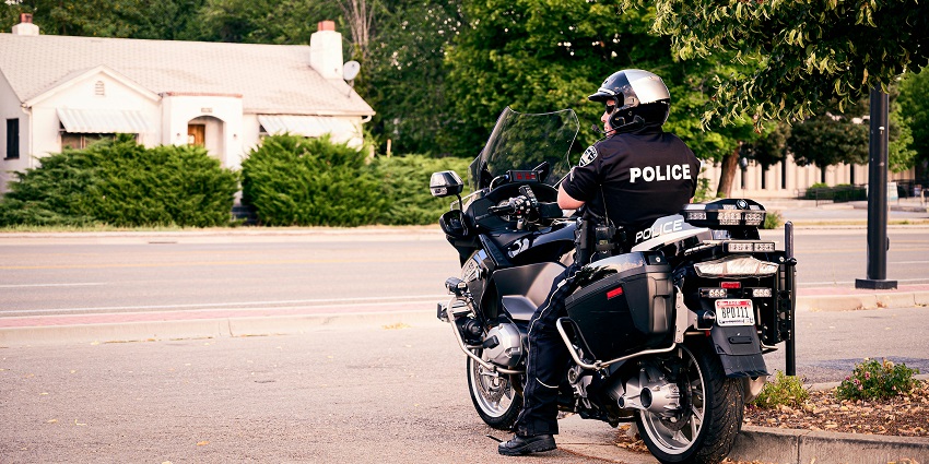 Police officer on patrol in a calm neighborhood, highlighting what is the safest city in Canada.
