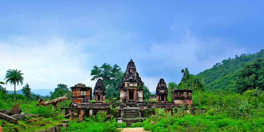 Dense forest with crumbling temples and scenic treks offering rustic natural beauty.
