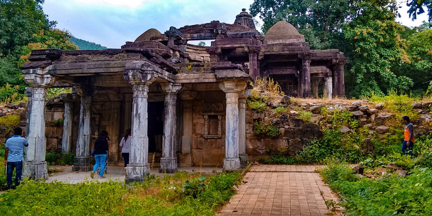 Mystical forest with temple ruins, river streams, and dense greenery near Vijaynagar.