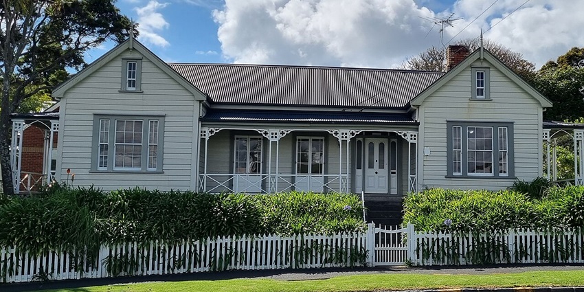 Pompallier Mission house and Printery with white building, fencing and multiple windows