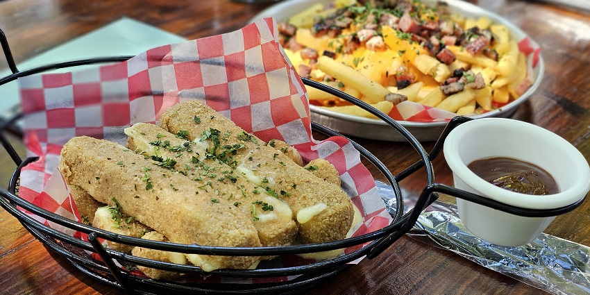 Plate of classic poutine with fries, cheese curds, and gravy