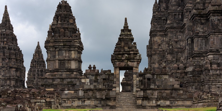 Ancient stone towers and the entrance gate of Prambanan Temple, one of the historical places in Indonesia.