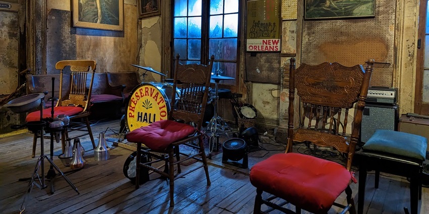 Intimate interior of Preservation Hall with jazz musicians performing.