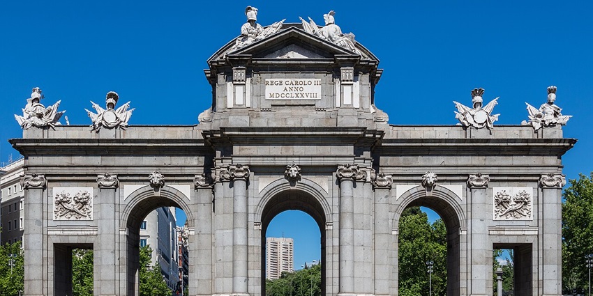 Puerta de Alcalá with detailed statues on the gate, intricate carvings and signage on top