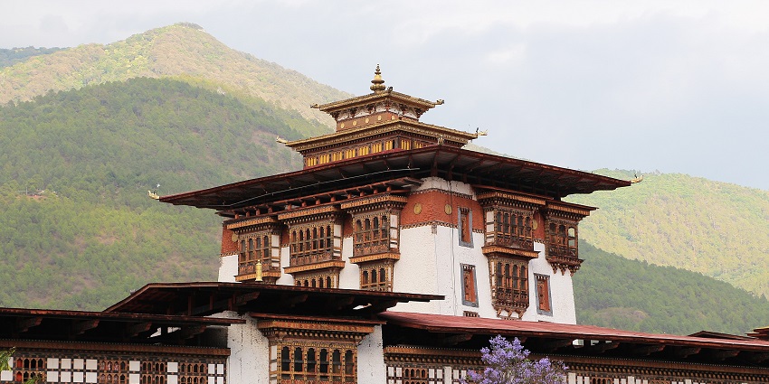 Punakha Dzong with traditional Buddhist architecture and mountains, one of the best places to visit in Bhutan in February.