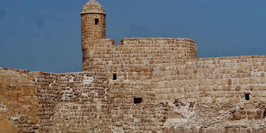 The towering stone walls of Qal'at al-Bahrain highlight one of the most iconic historical places in Bahrain