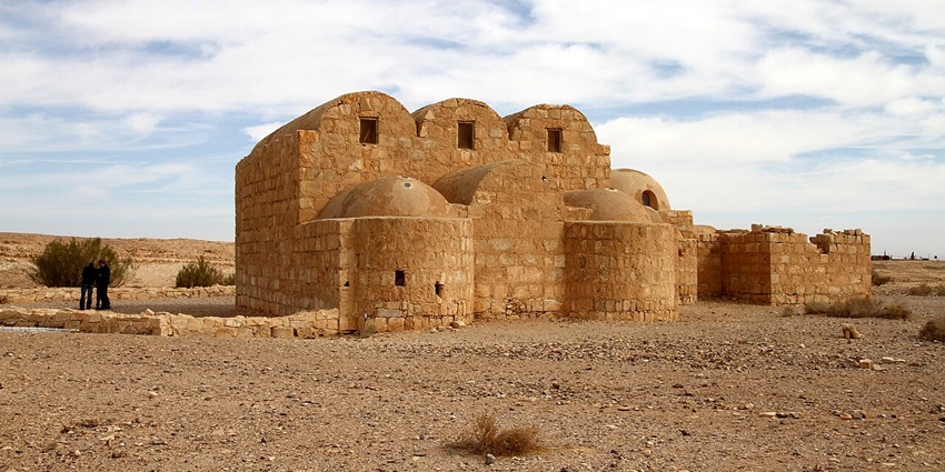 Qasr Amra with a small old sandstone structure in the middle of the desert, Jordan