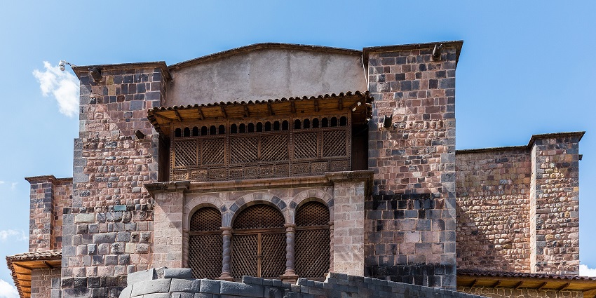 Front facade of Qorikancha temple with traditional Peruvian architecture and broken walls