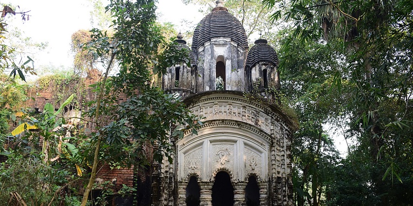 Raghunath temple with old architecture, intricate carvings, small stairs and green trees.