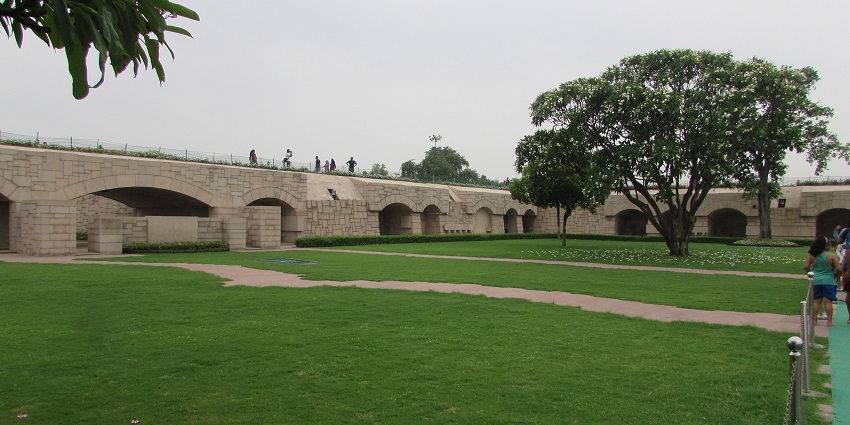 Raj Ghat in Delhi with green grass plains and a walking pathways, one of the top places to visit in Delhi in October.