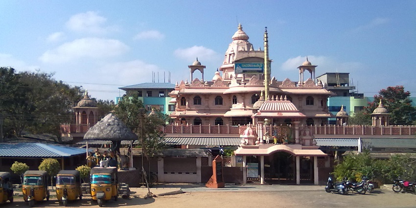 Beautifully sculpted temple with domes, entrance tower, and parked auto-rickshaws, one of the best places to visit in Andhra Pradesh in March.