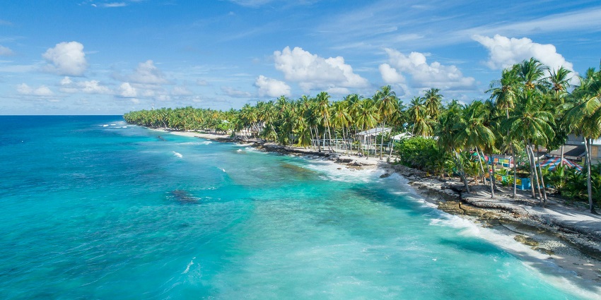 Rangali Island with overwater villas surrounded by turquoise ocean and white sand beaches.