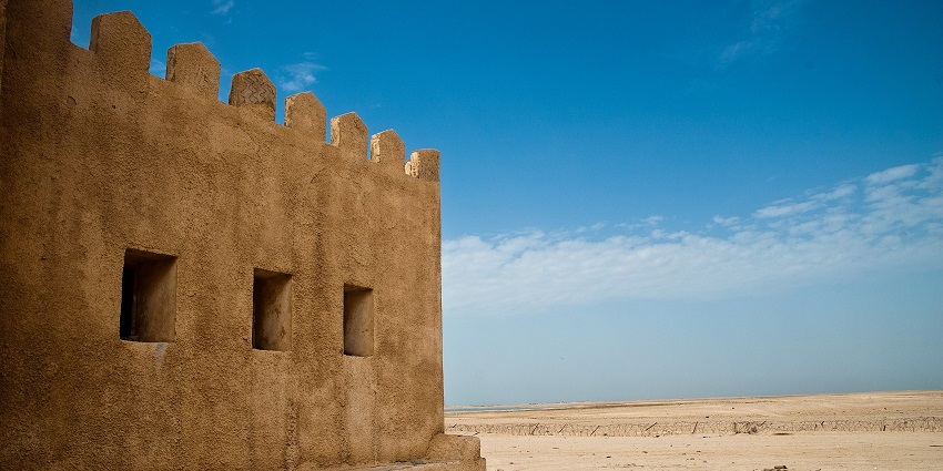 A view from a few windows of Ras Al Khaimah’s Dhayah Fort in a desert on a bright sunny day.