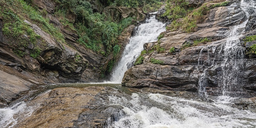 Ravana Falls, with water flowing it is one of the historical places in Sri Lanka