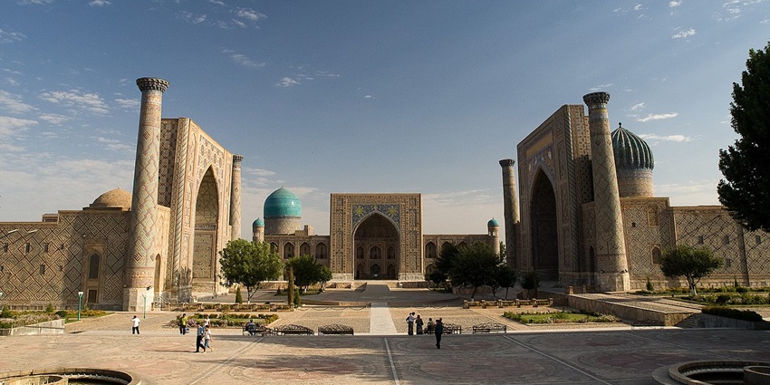 Registan in Samarkand with traditional Islamic architecture, multiple minarets and people