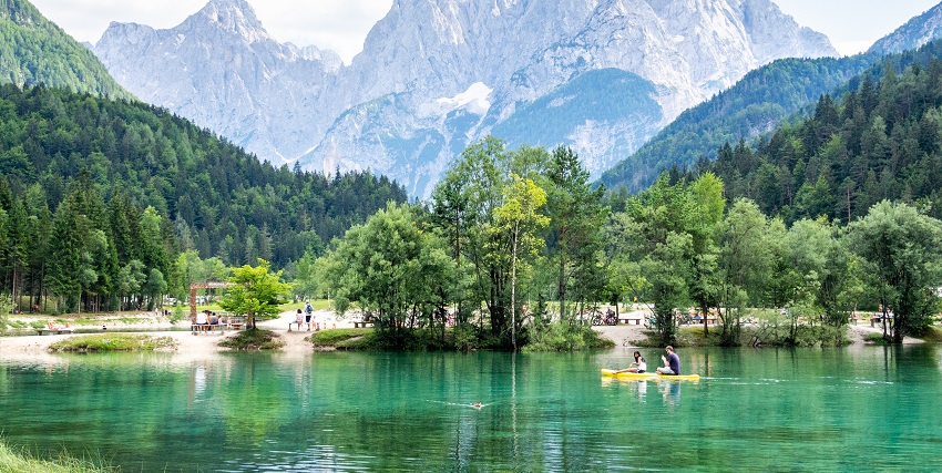 Things to do in Slovenia include relaxing at the serene Lake Jasna, surrounded by mountain peaks.